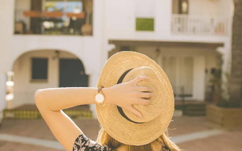 Woman holding hat